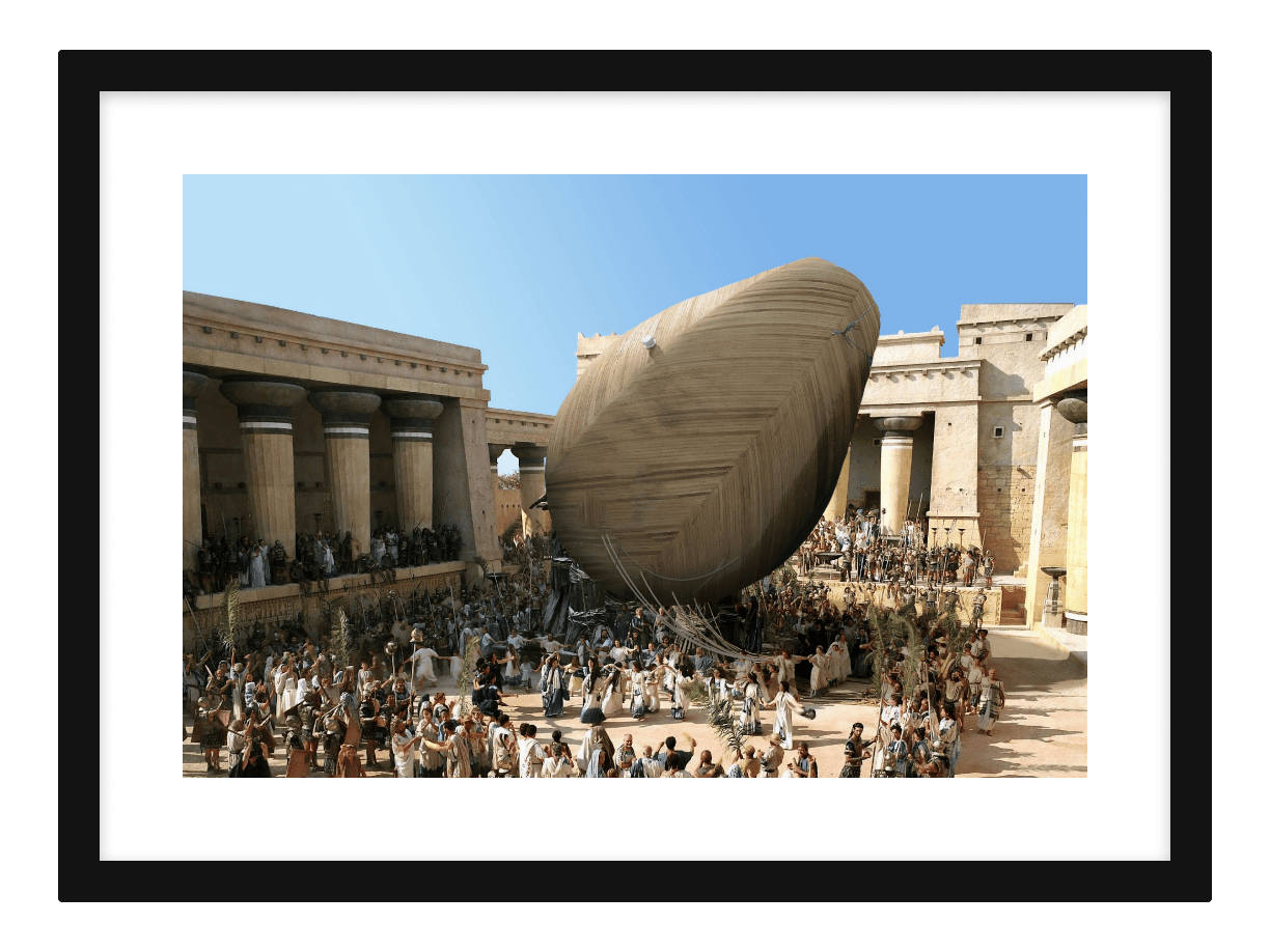 Framed mythological painting that represents a scene from the Trojan War. Instead of the a wooden horse, there's a giant wooden avocado dragged into the City of Troy.